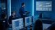 Team of Professional IT Developers Have a Meeting, Speaker Shows Growth Data with Graphs, Charts, Software UI. Shown on TV. Concept: Software UI Development, Deep Learning, Graphs, Charts.